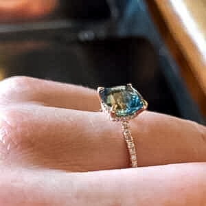 A photo from a customer review featuring a Montana sapphire set in a ring not made by Earth's Treasury