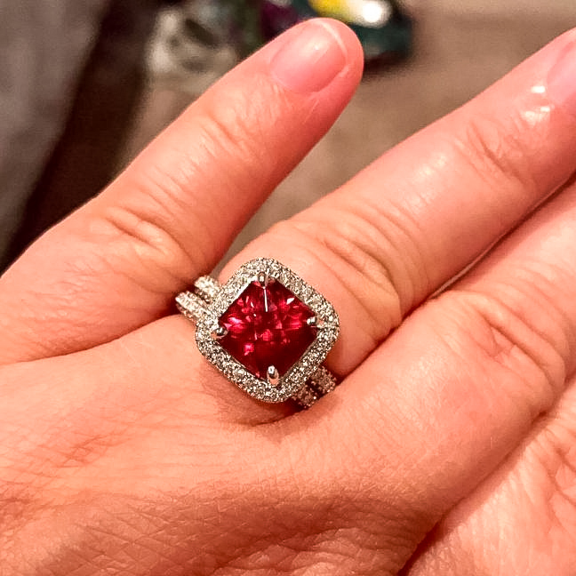 A photo from a customer review featuring a garnet set in a ring not made by Earth's Treasury