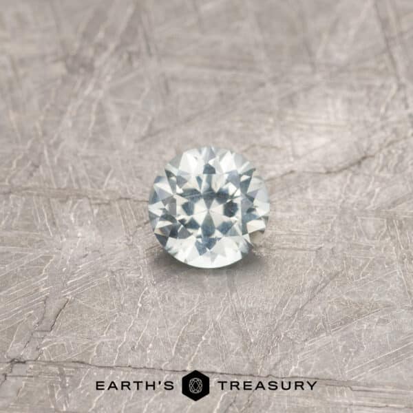 A white Montana sapphire in a classic diamond round brilliant design