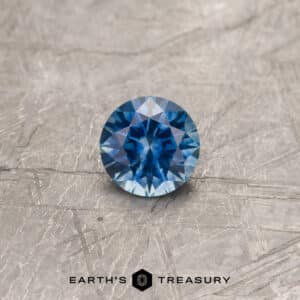 A blue Montana sapphire in a classic diamond round brilliant design