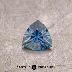 A blue Montana sapphire in a custom trillion design