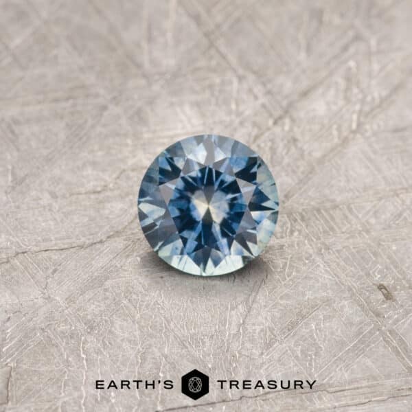 A particolored Montana sapphire in a classic diamond round brilliant design