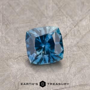 A blue-green Montana sapphire in our "Aurora" square cushion design