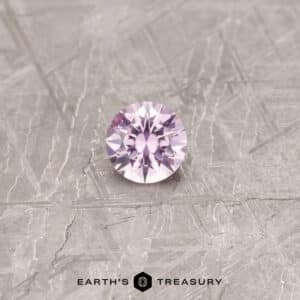 A pink Montana sapphire in a classic diamond round brilliant design