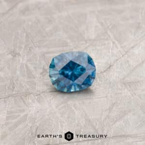 A blue-green Montana sapphire in our "Hyperbola" oval design