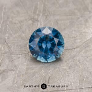 A blue Montana sapphire in a classic diamond round brilliant design