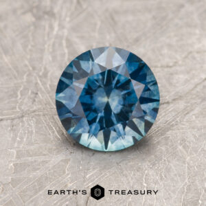 A blue Montana sapphire in a classic diamond round brilliant design