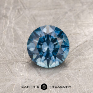 A blue Montana sapphire in a classic diamond round brilliant design