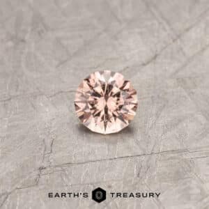 A peach Mahenge garnet in a classic diamond round brilliant design