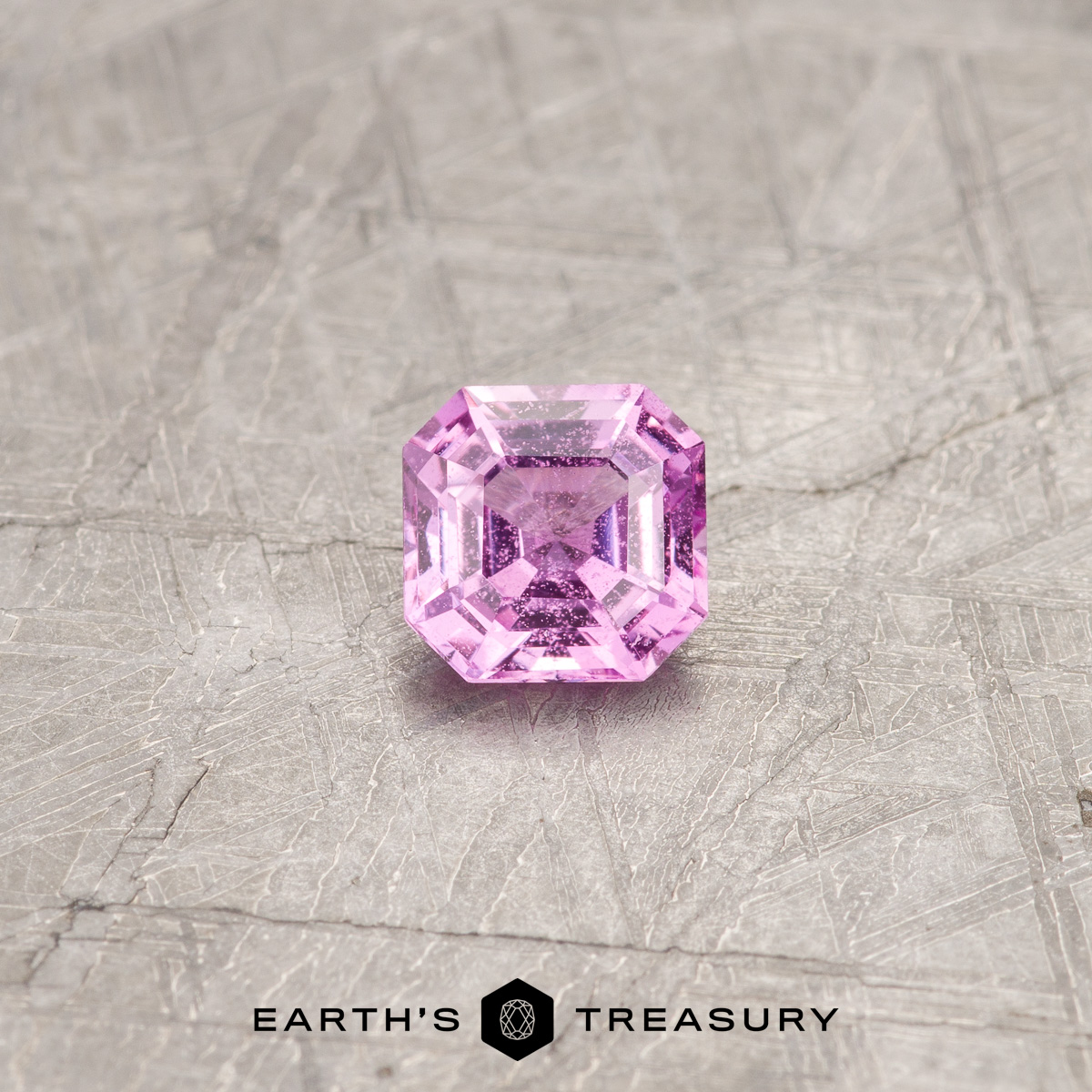 A hot pink sapphire in a classic asscher-style square design