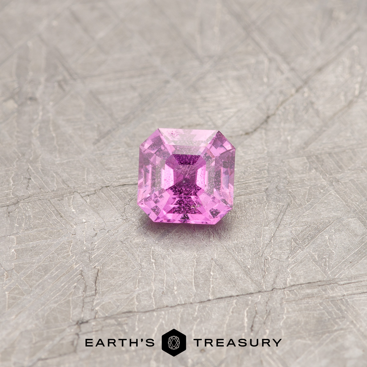 A hot pink sapphire in a classic asscher-style square design