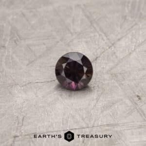 A purple Umba sapphire in a classic diamond round brilliant design