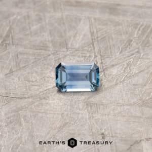 A blue Montana sapphire in a classic emerald cut