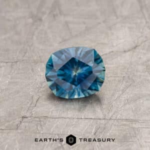 A blue-green Montana sapphire in our "Hyperbola" oval design