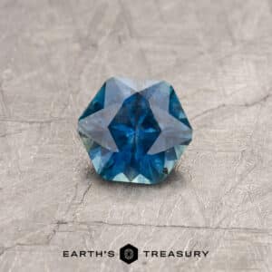 A blue-green Montana sapphire in our "Sparkling Snowflake" hexagon design