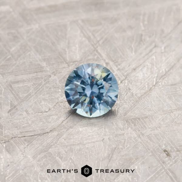 A particolored Montana sapphire in a classic diamond round brilliant design