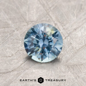 A particolored Montana sapphire in a classic diamond round brilliant design
