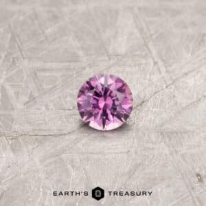 A pink Montana sapphire in a classic diamond round brilliant design