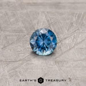 A blue Montana sapphire in a classic diamond round brilliant design
