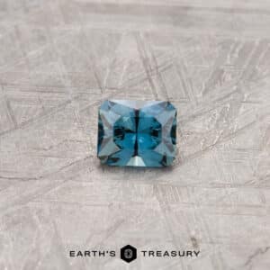 A blue-green Australian Sapphire in our "Fourth of July" rectangle design