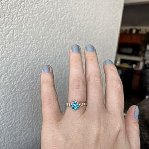 A photo from a customer review featuring an "Anthea" ring in 14k yellow gold with 1.71-Carat Montana Sapphire