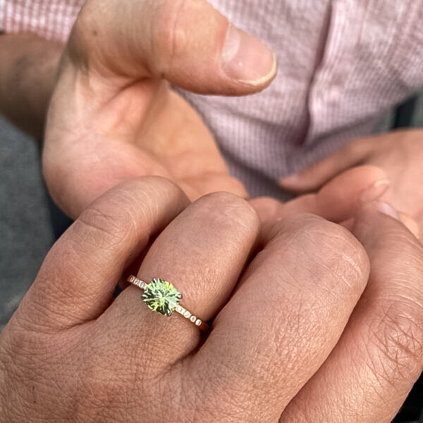 A photo from a customer review featuring a "Karelia" ring in 20k pink gold and platinum, with 1.43-Carat Montana Sapphire