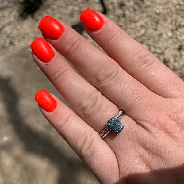 A photo from a customer review featuring a "Tiara" ring in 18k white gold with 2.85-carat Montana sapphire, alongside a"Kivu" Band in 18k white gold