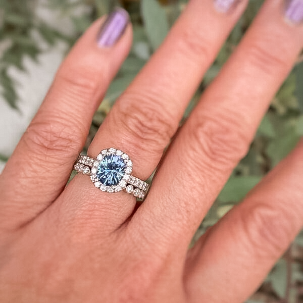 A photo from a customer review featuring a classic pave halo ring in platinum with 2.07-Carat Montana sapphire, alongside the "Loire" band in platinum