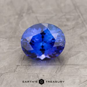 A bright blue tanzanite in a custom oval design
