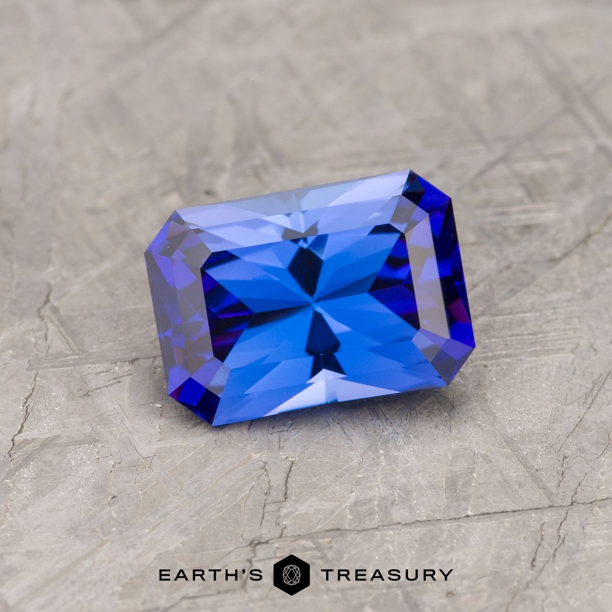 A bright blue tanzanite in a custom rectangle design