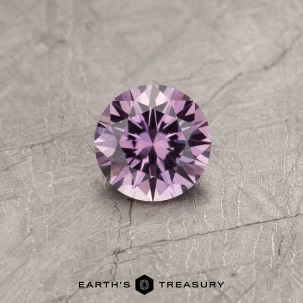A color change Montana sapphire in a classic diamond round brilliant design