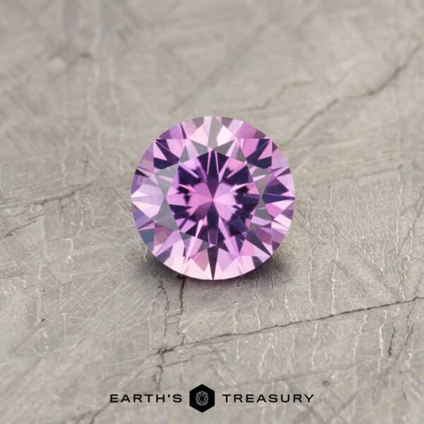 A color change Montana sapphire in a classic diamond round brilliant design