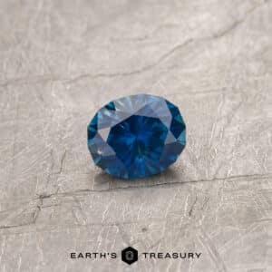 A dark blue Montana sapphire in our "Serendipity" oval design