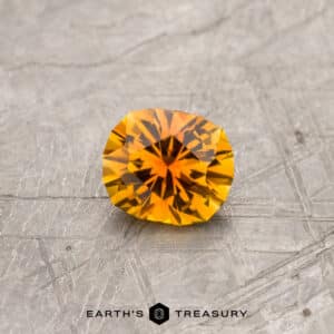 An orange Montana sapphire in our "Hyperbola" oval design