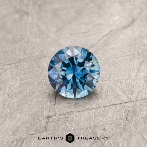 A teal Montana sapphire in a classic diamond round brilliant design