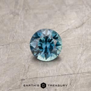 A teal Montana sapphire in a classic diamond round brilliant design