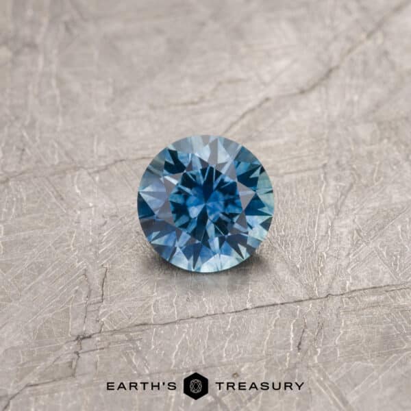 A blue Montana sapphire in a classic diamond round brilliant design