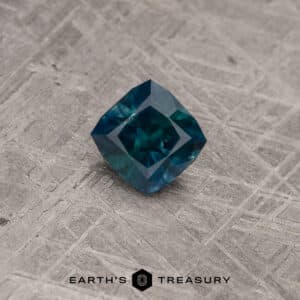 A blue-green Montana sapphire in our "Aurora" square cushion design