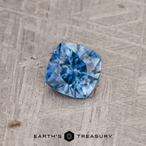 A blue-green Montana sapphire in our "Stella" square design
