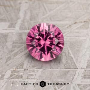 A pink spinel in in a classic diamond round brilliant design