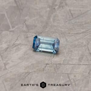 A particolored Montana sapphire in a classic emerald cut