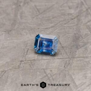 A blue Montana sapphire in a classic emerald cut