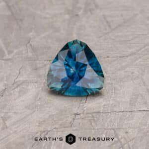 A blue-green Montana sapphire in a custom trillion design