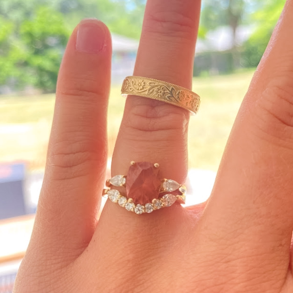 The "Clematis" ring in 14K yellow gold with 2.75-Carat Mahenge Garnet, the "Clematis" band in 14K yellow gold, and the "Hawthorne" band in 14K yellow gold