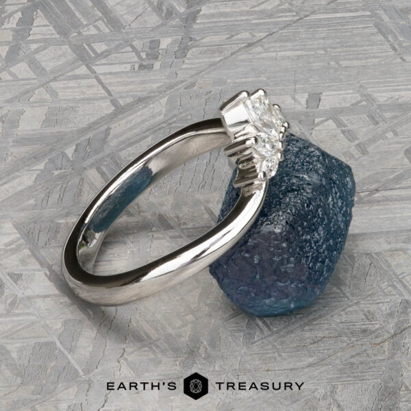 The "Vilaine" band in platinum The "Vilaine" band in platinum is showcased atop a rough blue stone with a textured gray backdrop—ideal for any Vilaine Band fan looking to express their unique style.