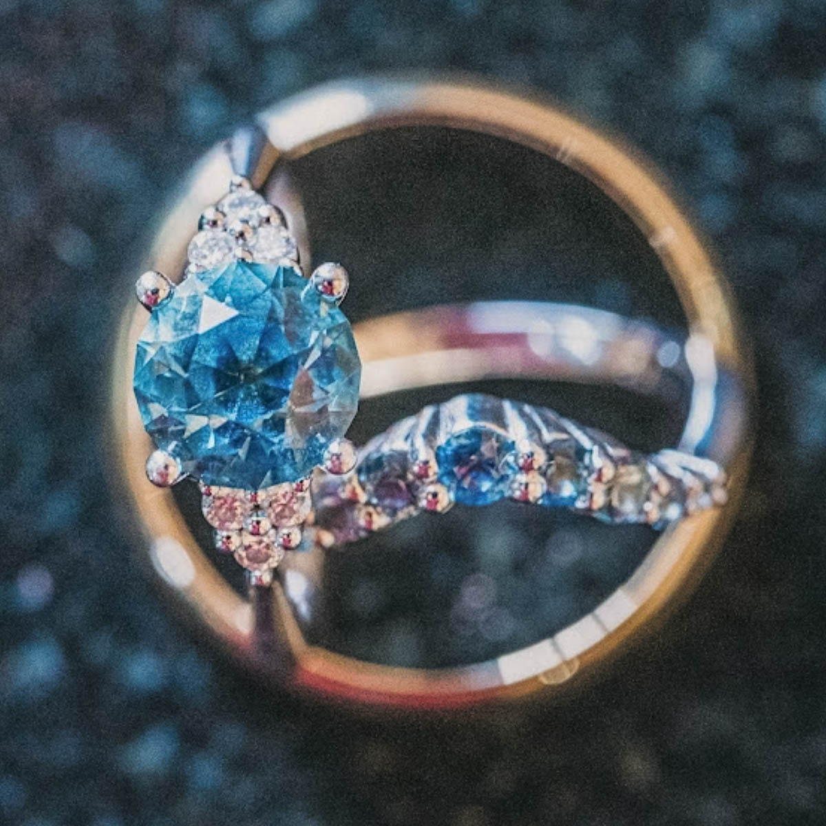 The "Kacie" in 14K white gold with 2.47-Carat Montana Sapphire, alongside the ombre "Rhine" band in 14K white gold and a yellow gold men's band
