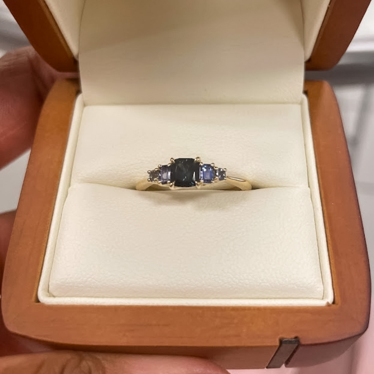 A custom five-stone ring in 14K yellow gold with a 0.64-carat Montana sapphire
