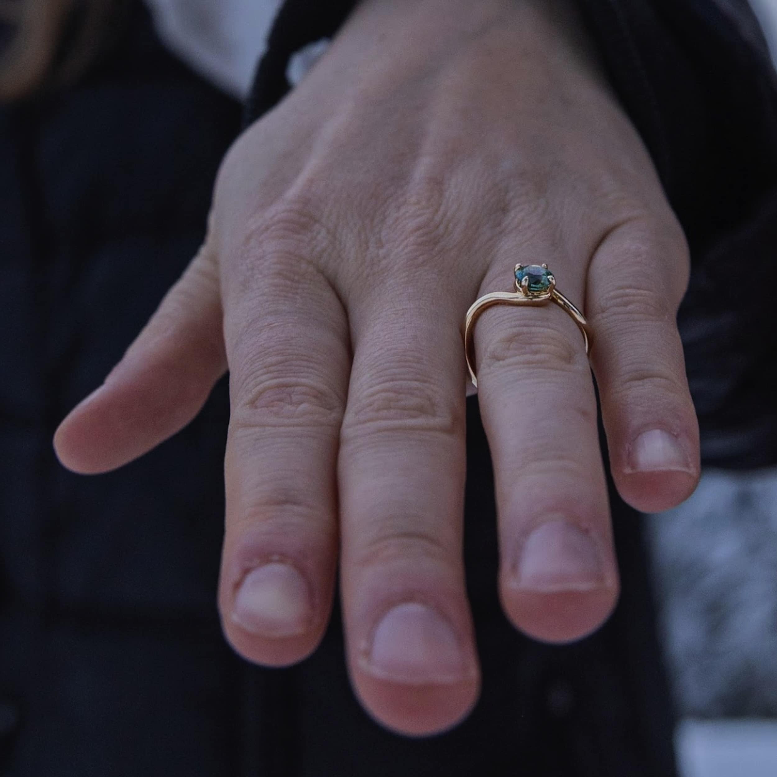 An engagement photo featuring a custom twisted gold solitaire.