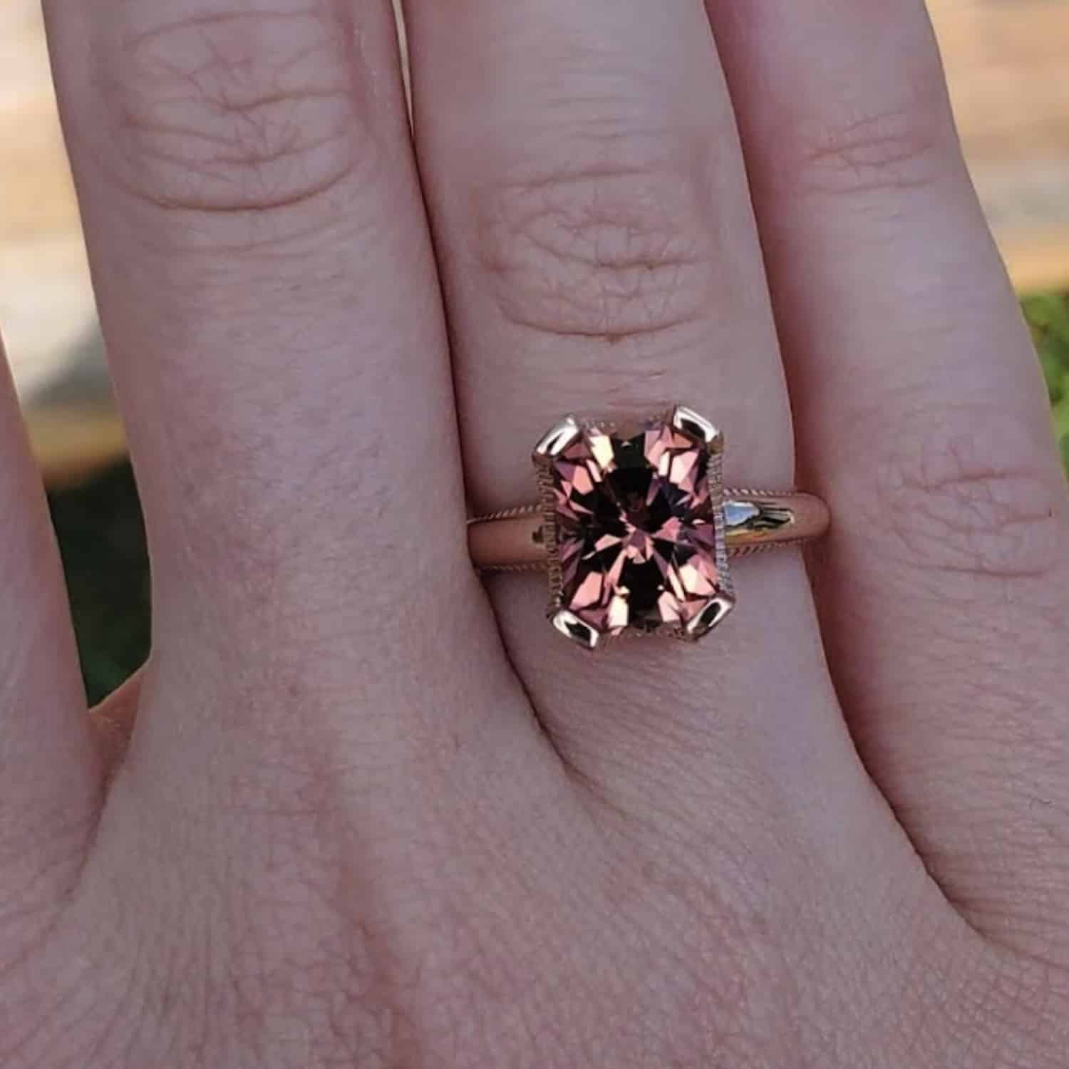 A photo from a customer review featuring a pink tourmaline in a pink gold "Narcissus" ring on the customer's right hand.