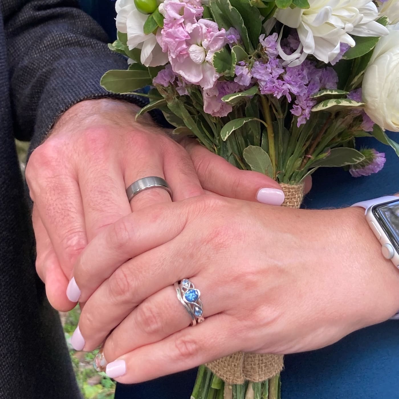 A photo form a customer review featuring the "Isolde" ring in 14k white gold with 1.00-carat Montana sapphire, alongside the custom-fit contour band in 14k white gold